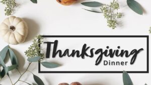 Thanksgiving dinner banner with a background of gourds and eucalyptus leaves.